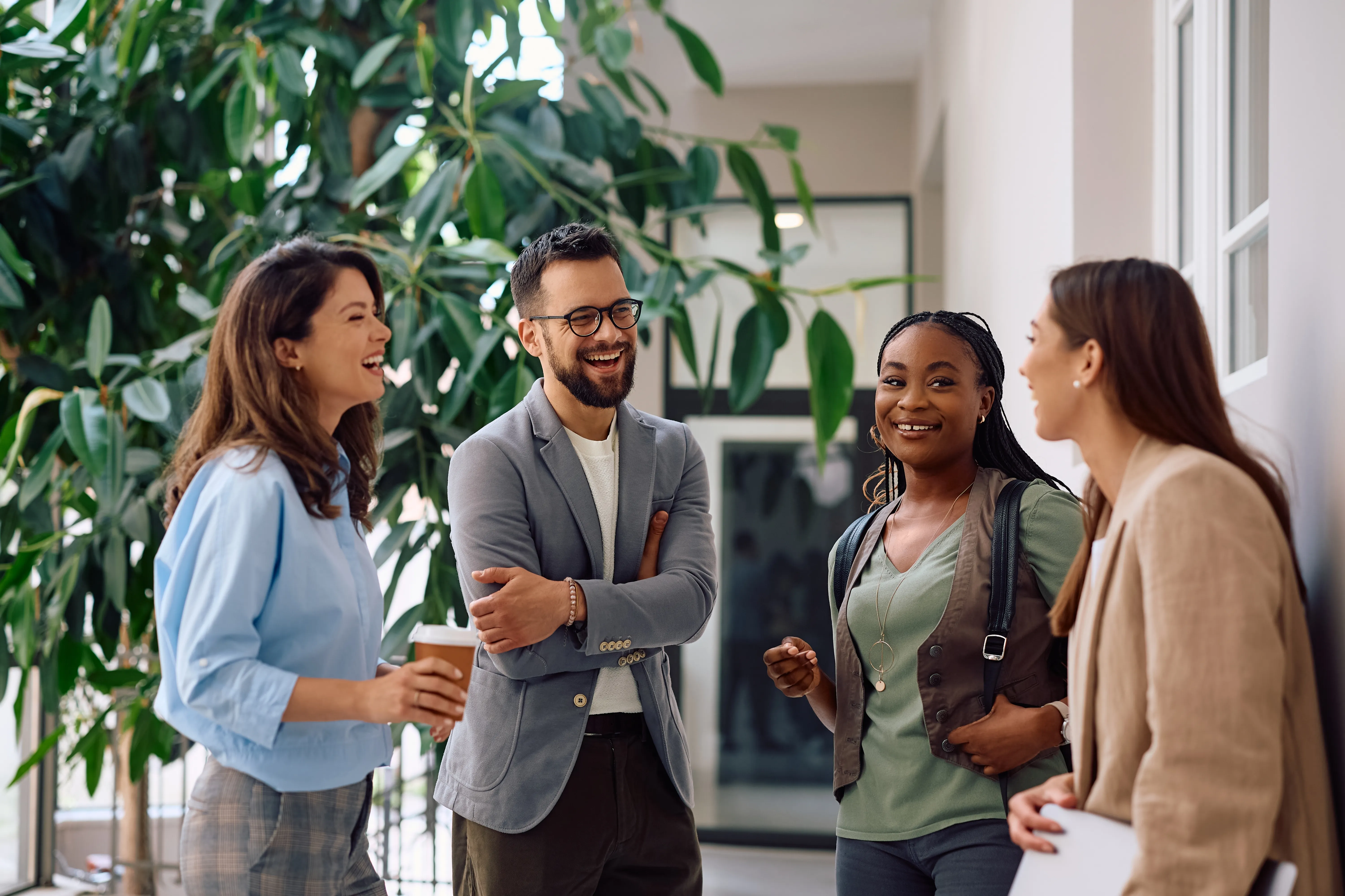 Team chatting in the office hallway