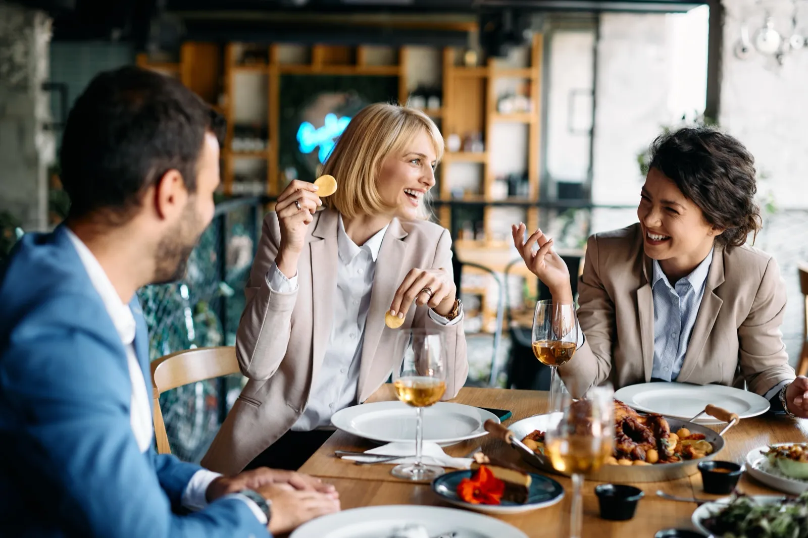 Colleagues laughing together at a restaurant