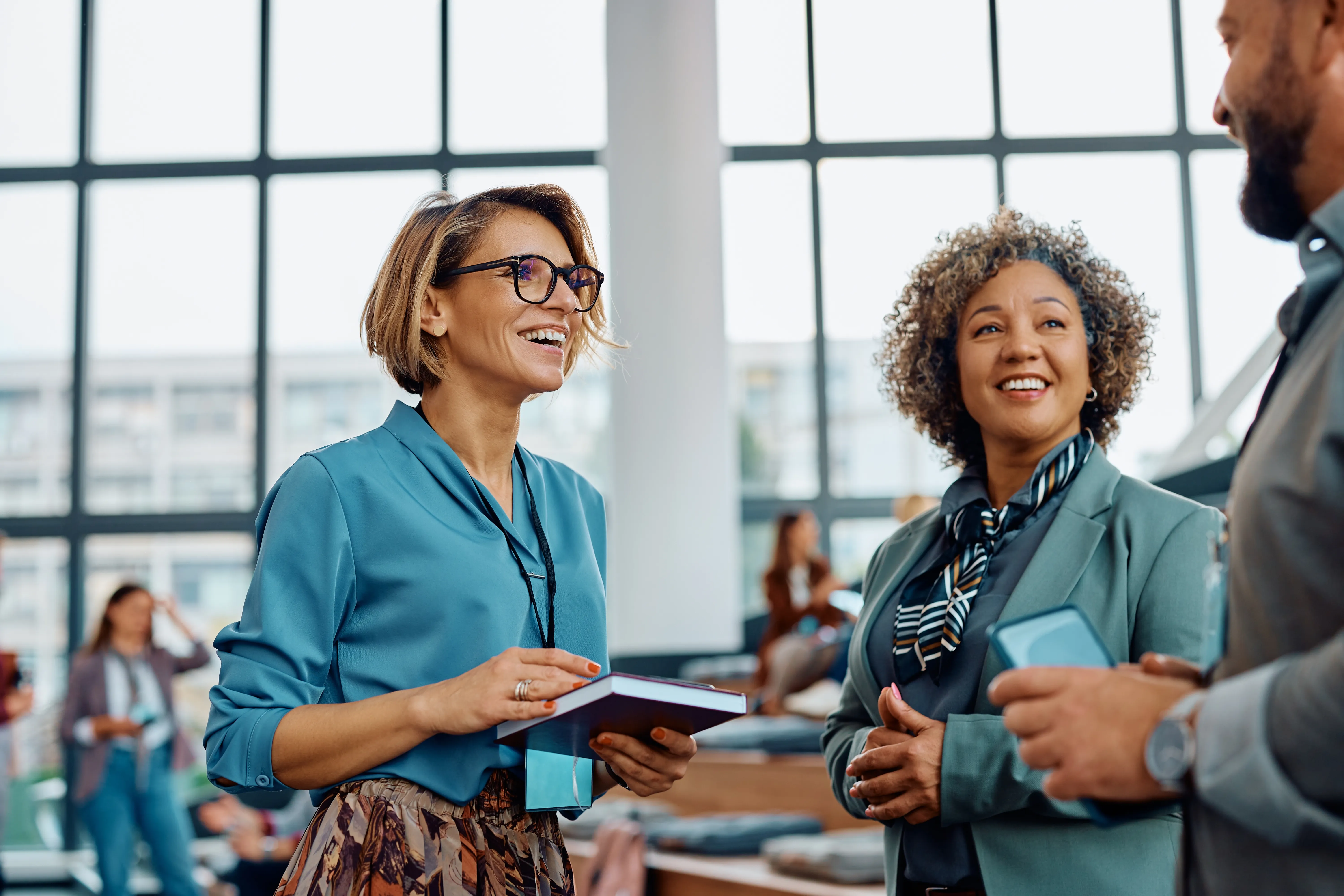 Colleagues laughing together at a professional event